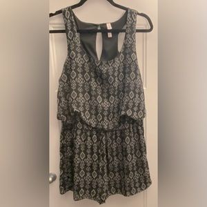 A patterned grey and black, sleeveless, short romper